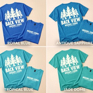May include: Four t-shirts in different colors: royal blue, antique sapphire, tropical blue, and jade dome. Each shirt has a white graphic of pine trees and the text "BACK VIEW" and "MOCKUPS STUDIO". Each shirt is paired with a folded matching shirt.
