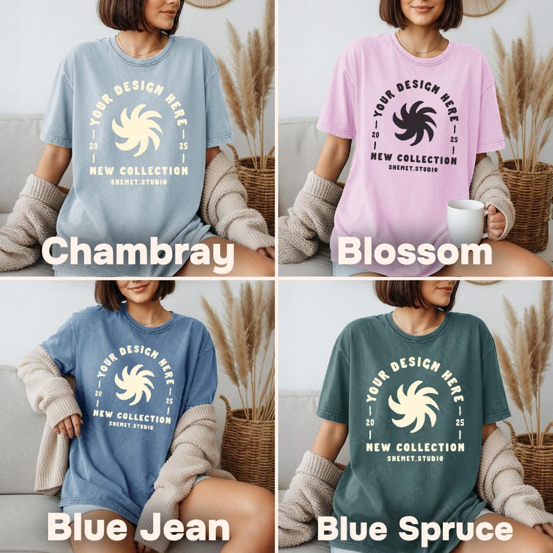 May include: Four t-shirts in different colors: chambray, blossom, blue jean, and blue spruce. Each shirt has a round graphic with the text "YOUR DESIGN HERE" and "NEW COLLECTION SHEMET.STUDIO". The shirts are short-sleeved and have a relaxed fit.