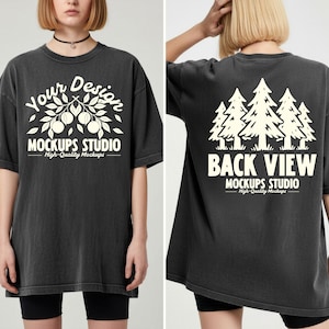 May include: Dark gray oversized t-shirt with a white graphic on the front that reads "Your Design Mockups Studio". The back of the shirt features a white graphic of trees and the text "Back View Mockups Studio".