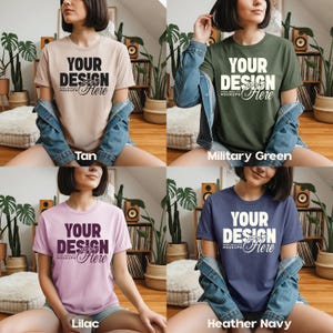 May include: Four t-shirts in tan, military green, lilac, and heather navy. Each shirt has the text "YOUR DESIGN Here" in white. The shirts are short-sleeved and appear to be made of a soft material. The word "MOCKUPS" is also visible.