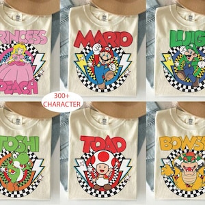 May include: Six cream-colored t-shirts featuring Nintendo characters Princess Peach, Mario, Luigi, Yoshi, Toad, and Bowser. Each shirt displays the character name in bold letters above a circular checkered graphic with lightning bolts and stars.