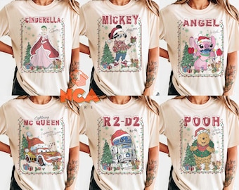 May include: Beige t-shirts featuring Christmas-themed character designs. Designs include Cinderella, Mickey Mouse, Angel, Lightning McQueen, R2-D2, and Pooh. Each design is framed with a festive border of lights and Christmas trees.