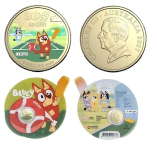 May include: A 2027 Australian 1 dollar coin featuring Bluey characters playing cricket on one side and King Charles III on the other. The coin is presented in circular packaging with a red cricket ball graphic and technical specifications.