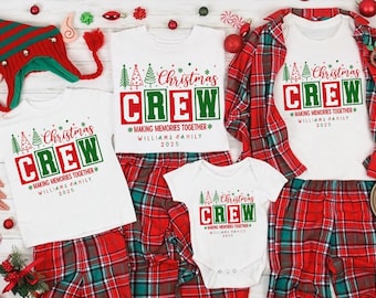 May include: A collection of white t-shirts and a baby bodysuit featuring the red and green text Christmas CREW, Making Memories Together, Williams Family 2025, and tree graphics. The set includes red and green plaid trousers and a striped elf hat.