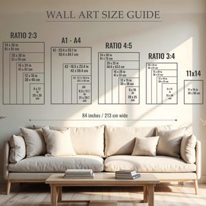 May include: A wall art size guide with various rectangular dimensions in inches and centimeters. The guide includes ratios like 2:3, 4:5, and 3:4, along with A1-A4 sizes. The text "WALL ART SIZE GUIDE" is at the top. The scene includes a beige sofa and a wooden coffee table.