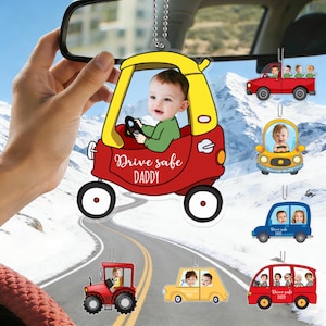 May include: A collection of car air fresheners featuring cartoon cars with photos of children. The main air freshener is a red and yellow car with a baby and the text "Drive safe DADDY". Other cars are red, yellow, and blue.