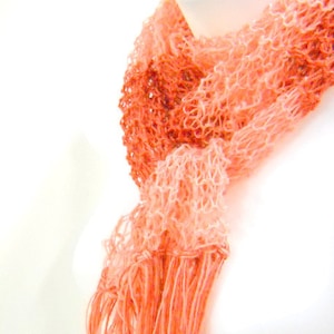 Orange striped knit scarf, to complete your Ms Poppins costume.  Lightweight, wispy apricot and orange with fringe on the ends. Made with acrylic yarn.