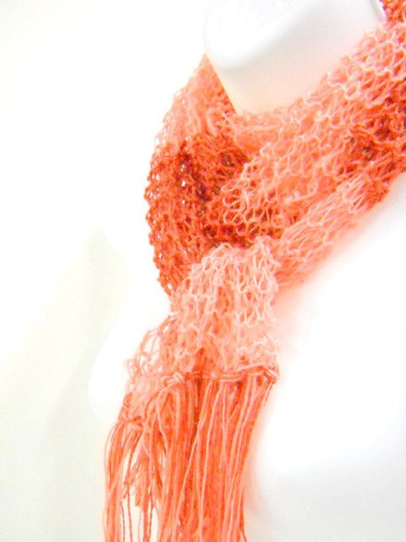 Orange striped knit scarf, to complete your Ms Poppins costume.  Lightweight, wispy apricot and orange with fringe on the ends. Made with acrylic yarn.