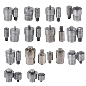 May include: A collection of various metal rivet setting tools, each with a cylindrical body and a smaller, threaded component. The tools are arranged in rows, showcasing different sizes and shapes for crafting and repair projects.