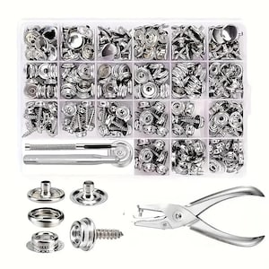 May include: A clear plastic organizer filled with various silver metal snap fasteners, screws, and tools. The kit includes a snap setter tool and a hole punch. The fasteners are in different shapes and sizes, suitable for various projects.