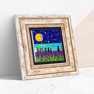 May include: Framed artwork featuring a whimsical scene of cats perched on a fence under a starry night sky with a crescent moon. The artwork has a white wooden frame. The cats are various colors, and the fence is purple.