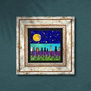 May include: A framed artwork depicts a whimsical night scene. A row of stylized cats sits on a purple fence, beneath a starry blue sky and a large yellow moon with a sleeping cat. The frame is white with a distressed finish.