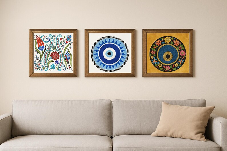 May include: Three framed wall art pieces with brown wooden frames. The art features floral and geometric designs in blue, red, yellow, and green. The artwork is displayed above a gray sofa with a beige pillow.