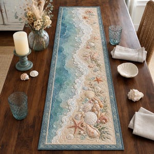 May include: A rectangular table runner featuring a coastal scene with a sandy beach, turquoise ocean waves, white sea foam, and various seashells and starfish. The design is bordered by a blue frame and includes intricate textures and patterns.