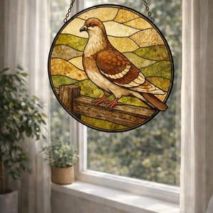 May include: A round stained glass window depicting a brown and white pigeon perched on a wooden fence. The background features a landscape of rolling hills in shades of green and yellow. The window is suspended by a chain.