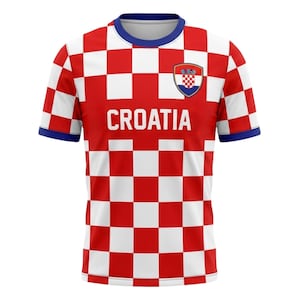 May include: A Croatia soccer jersey with a red and white checkered pattern. The word "CROATIA" is printed in white across the front. The jersey has a blue collar and sleeve cuffs, and a Croatian coat of arms is on the chest.