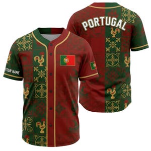 May include: A baseball jersey in burgundy and green, featuring a repeating pattern of roosters, crosses, and floral designs. The jersey includes the Portuguese flag and the word "PORTUGAL" on the back. The text "YOUR NAME" is on the left sleeve.