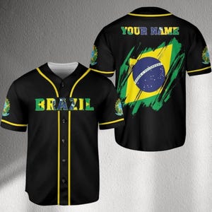 May include: Black baseball jersey with yellow trim and the word "BRAZIL" in green and blue. The back features the Brazilian flag and the text "YOUR NAME" in green. The jersey has short sleeves and a button-up front.