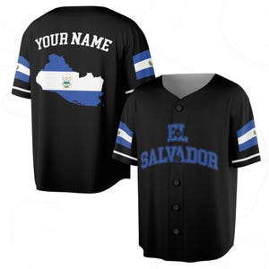 May include: Black baseball jersey with the text "EL SALVADOR" in blue on the front. The back features a map of El Salvador with the flag colors and the text "YOUR NAME". The sleeves have blue and white stripes.