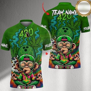 May include: Green polo shirt with a colorful graphic featuring a cartoon monkey smoking a cigar, wearing a green hat and glasses, and meditating. The shirt has the number "420" and cannabis leaves. The text "TEAM NAME" and "YOUR" are also visible.