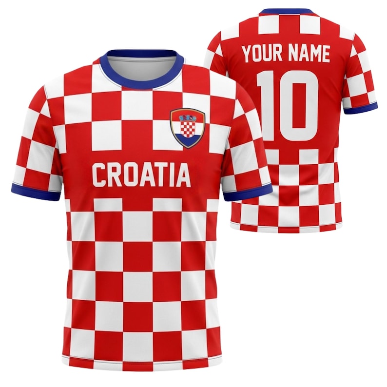 May include: A red and white checkered Croatia soccer jersey with the word "CROATIA" across the chest. The jersey has a blue collar and sleeve trim, and the Croatian coat of arms is on the chest. The back of the jersey has the number 10 and the text "YOUR NAME".
