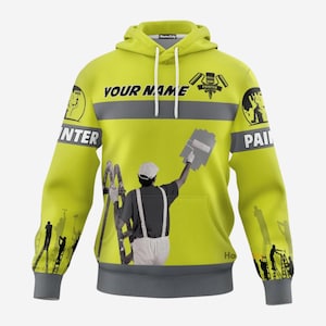 May include: A yellow hoodie with the text "YOUR NAME" and "PAINTER" printed on it. The hoodie features a painter graphic with a ladder and a paint roller. The sleeves and bottom hem are grey.