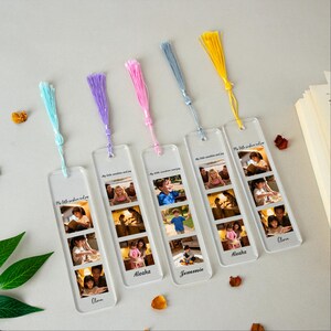 May include: Clear acrylic bookmarks with colorful tassels in blue, purple, pink, gray, and yellow. Each bookmark features a series of family photos and the text "My little sunshine and joy" along with a name. A personalized gift for book lovers.