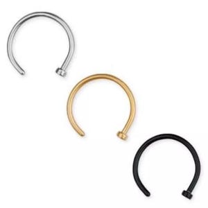 May include: Three nose rings in silver, gold, and black. Each ring is a simple, open hoop design with a small, rounded post on one end. The rings are displayed against a plain white background.