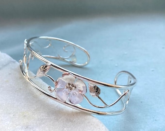 Dainty open work floral bangle. Hand made in sterling silver. Wild rose flowers and leaves. Hallmarked.