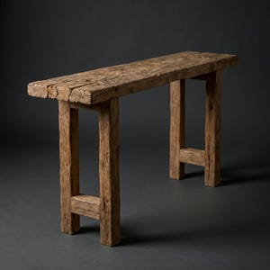 May include: A rectangular console table constructed from weathered, light brown reclaimed wood. The piece features a thick, textured tabletop surface supported by four sturdy, straight legs connected by horizontal crossbars at the base.