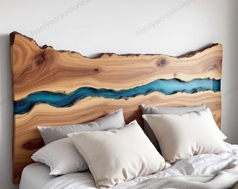 May include: A wooden headboard with a live edge design. The headboard features a river of blue resin flowing through the center. The headboard is placed above a bed with white pillows and a gray blanket.