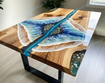 May include: A wooden table with a unique design featuring a blue resin river and ocean wave details. The table has a rectangular shape with a black metal base. The wood has a natural grain pattern.