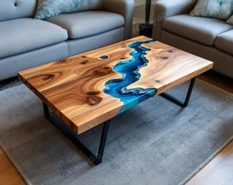 May include: A rectangular wooden coffee table with a river of blue resin flowing through the center. The table has a natural wood grain finish and sits on black metal legs. The table is approximately 48 inches long and 24 inches wide.