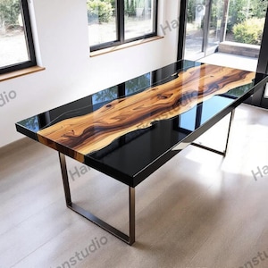 May include: A rectangular dining table with a black glossy surface and a natural wood grain center. The table has a modern design with a metal base and measures approximately 72 inches long.