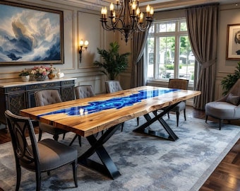 May include: A large wooden dining table with a blue resin river design. The table has a natural wood edge and sits on black metal legs. The room features a chandelier, artwork, and upholstered chairs, creating an elegant dining space.