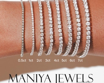 May include: A collection of diamond tennis bracelets of varying carat weights, from 0.5ct to 7ct, displayed on a wrist. The bracelets are set in a silver metal and sparkle brightly. The brand name "MANIYA JEWELS" is displayed below the bracelets.
