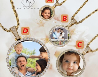 May include: Gold-toned pendant necklaces with diamond accents and a photo display. The pendants feature a round frame with a photo of a person or family. The necklaces have a rope chain design. The brand name "MANIYA JEWELS" is visible.