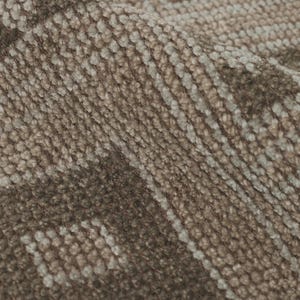 May include: Close-up of a textured, woven fabric in shades of brown and beige. The fabric has a repeating pattern of geometric shapes and lines, creating a subtle, yet intricate design. The material appears soft and slightly folded.