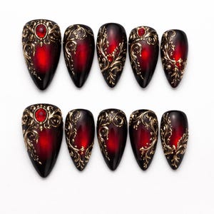 May include: A white ceramic mug with a black handle and the text "But First, Coffee" in a black, handwritten-style font. The mug is on a white surface.