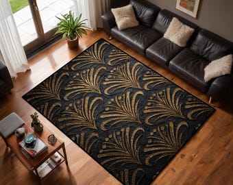 May include: A rectangular black area rug with a repeating gold leaf design. The rug is placed on a hardwood floor in a living room setting, with a leather sofa and a window visible in the background.