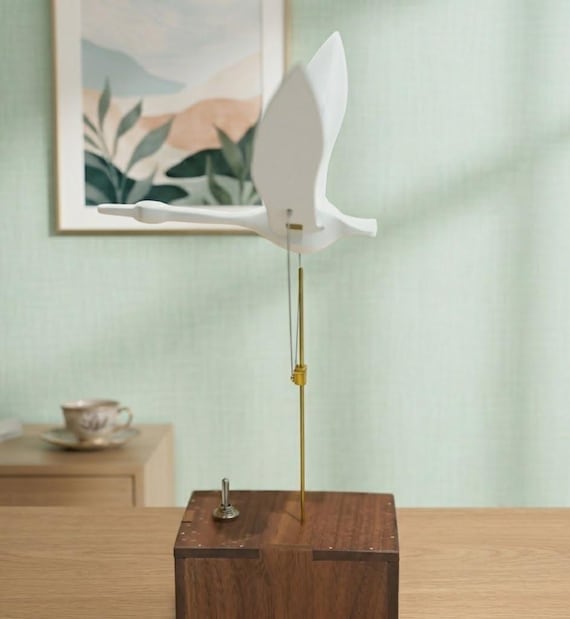 A handcrafted wooden swan automaton that actually moves — kinetic mechanical sculpture meets music box in a way that makes you stop and stare.