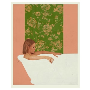 May include: A woman in a white bathtub with a green and gold floral wallpaper behind her.