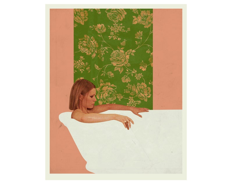 May include: A woman in a white bathtub with a green and gold floral wallpaper behind her.