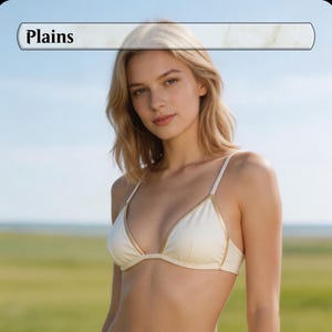 May include: A woman wearing a white bikini top with gold trim. The top has thin straps and a triangle shape. The word "Plains" is in a banner above the woman's head. The background is a field and a blue sky.