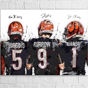 May include: A canvas print featuring three football players in black and orange uniforms, with their backs to the viewer. The players are Higgins, Burrow, and Chase, with their jersey numbers visible. The artwork has a watercolor effect.