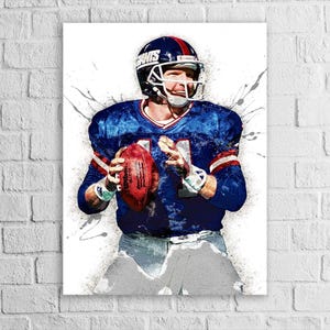 May include: Artwork of a football player in a blue jersey with red and white accents, holding a brown football. The player wears a helmet with the word "Giants" on it. The artwork has a watercolor effect with paint splatters.