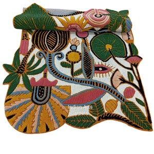 May include: A colorful, intricately designed rug with a white background and a variety of floral and leaf patterns in shades of green, yellow, pink, and blue. The rug features the text "Indian Arts Carpets".
