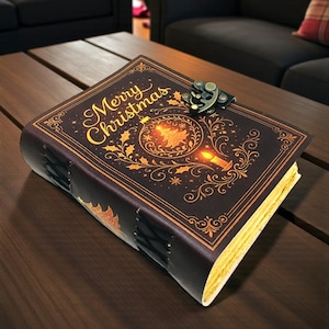 May include: A decorative journal with a dark brown cover featuring the words "Merry Christmas" in gold script. The cover design includes a Christmas tree, candle, and holly leaves. The journal has a metal clasp and stitched binding.