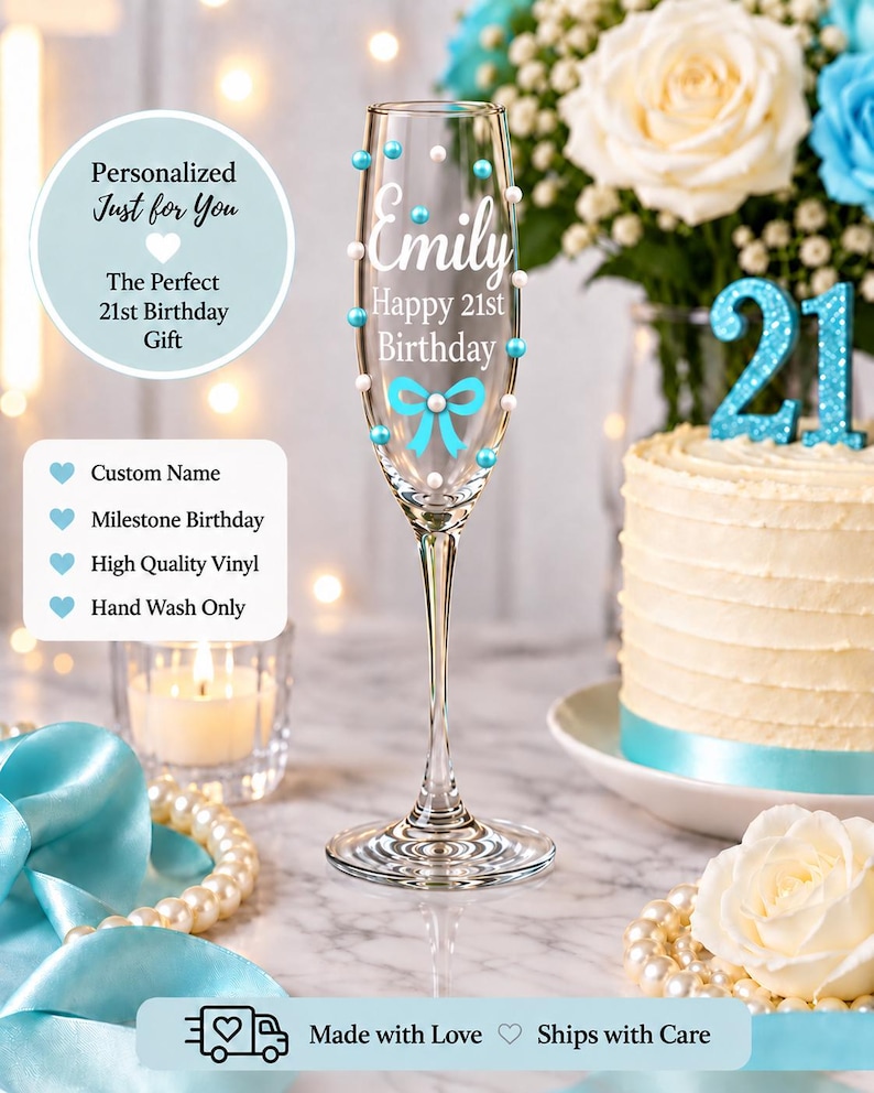 May include: A clear glass champagne flute decorated with white and light blue pearls, featuring the white text Emily, Happy 21st Birthday, and a light blue bow graphic. The glass has a slender stem and a circular base, standing upright.