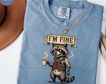 Camiseta divertida con diseño de mapache "Estoy bien", sarcástica, con colores que te hacen sentir bien y ansiosa.